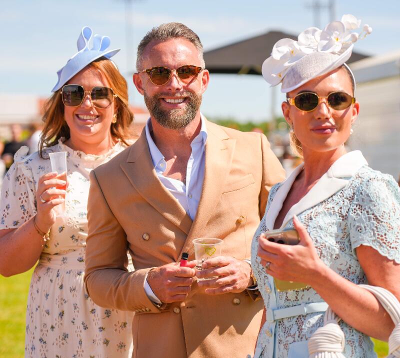 Two ladies and a gentleman dressed up at Chelmsford Racecourse.