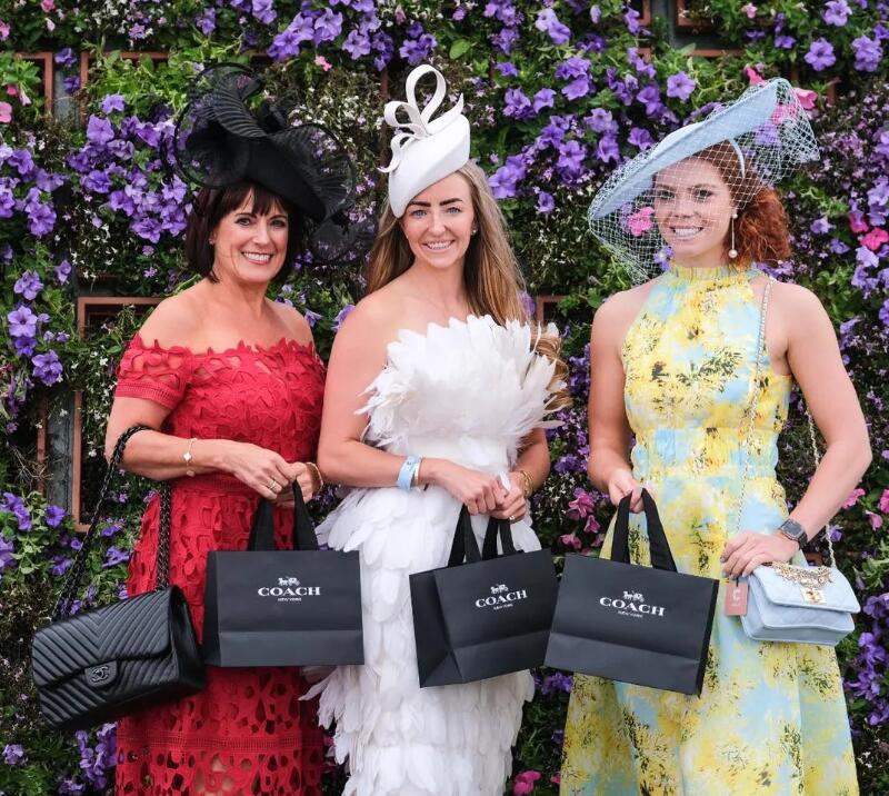 Racegoers with matching tote bags.