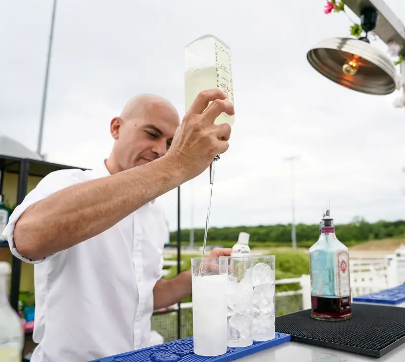 A barman prepping a drink.